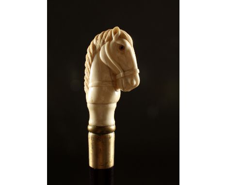 A BONE HANDLED WALKING STICK, carved as a horse. 36ins long.