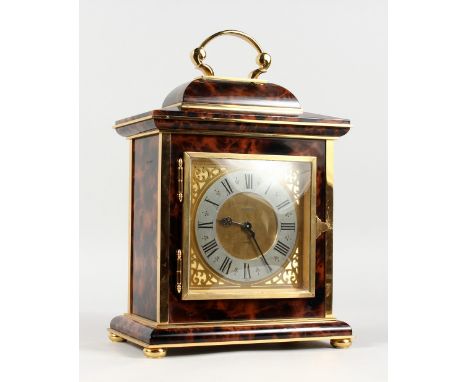 A SUPERB ASPREY LUXOR BRASS AND TORTOISESHELL BRACKET CLOCK, with silvered dial, black Roman numerals, carrying handle and bu