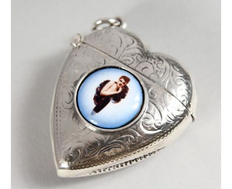 AN ENGRAVED SILVER HEART SHAPE VESTA CASE, with later enamel decoration.