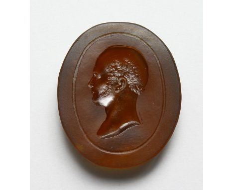 AN INTAGLIO CARVED AMBER GLASS BUST OF A MAN, in the Roman style. 2ins high.