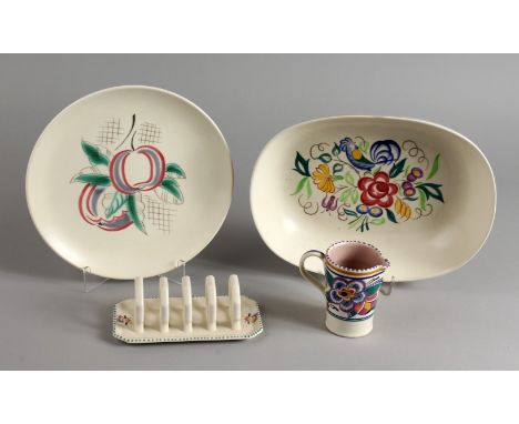 POOLE POTTERY, an oval shaped bowl, a circular plate painted with apples, a toast rack and a small jug (4). Dish: 12ins long.