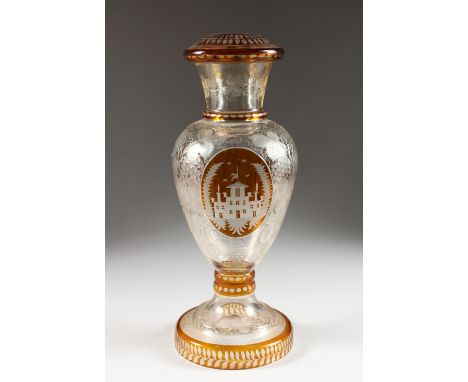 A LATE 19TH CENTURY BOHEMIAN AMBER TINTED GLASS LAMP BASE, engraved with a stately home and fruiting vines. 16ins high.