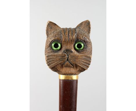 A GOOD CARVED CAT'S HEAD WALKING STICK HANDLE with glass eyes.