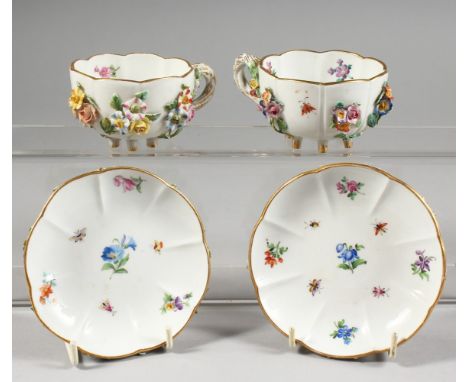 A GOOD PAIR OF MEISSEN FLOWER ENCRUSTED CUPS AND SAUCERS painted with insects. Cross swords mark in blue.