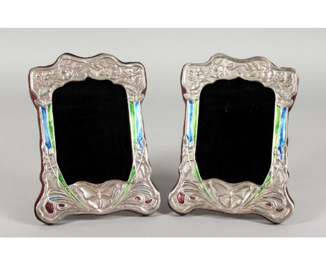 A PAIR OF ART NOUVEAU STYLE SILVER AND ENAMEL PHOTOGRAPH FRAMES, embossed with butterflies. 8ins x 6.5ins.
