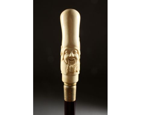 A BONE HANDLED WALKING STICK, carved as a Chinese man. 37ins long.