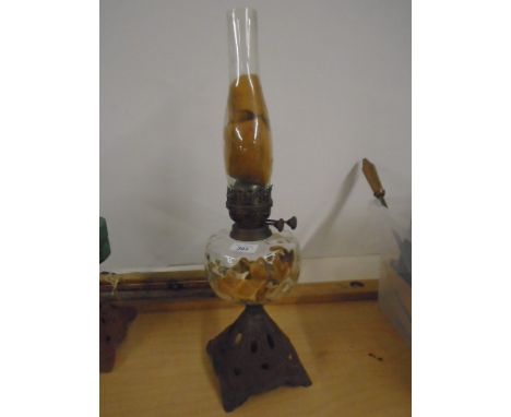 Oil lamp with cast iron base and glass reservoir
