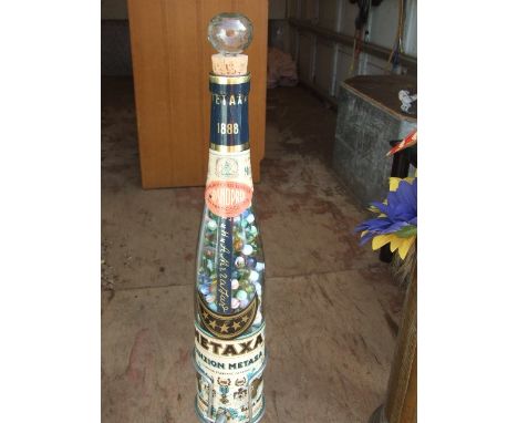 Vintage Metaxa Bottle on Metal Stand full of Marbles 33 inches tall including stand