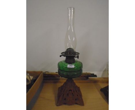 Oil lamp with cast iron base and glass reservoir