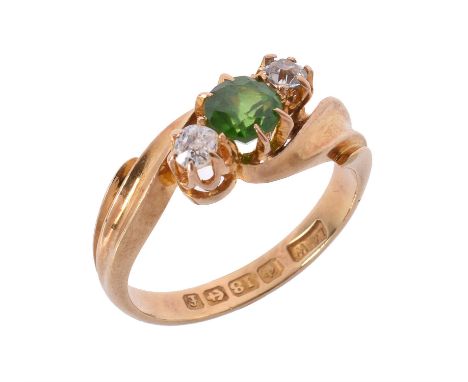 An Edwardian 18 carat gold demantoid garnet and diamond ring, the oval cut demantoid garnet claw estimated to weigh 0.56 cara