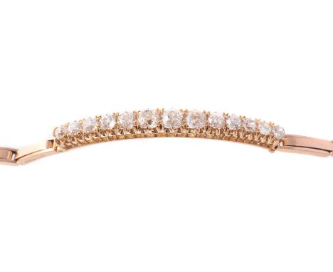 An Edwardian diamond bracelet, circa 1905, the arched top claw set with thirteen slightly graduated cushion shaped old brilli