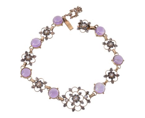 An Arts and Crafts amethyst and half pearl bracelet, circa 1900, set with seven cabochon amethysts in rub over mounts, with o