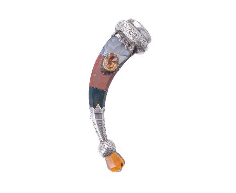 A mid Victorian Scottish hardstone hunting horn brooch, circa 1870, the scrolled floral decorated silver fitments with a foil
