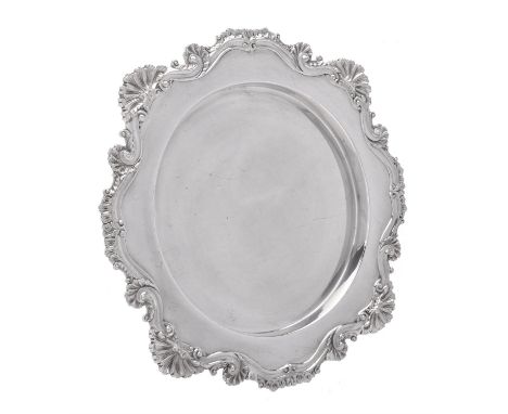 An Edwardian silver shaped circular salver by James Dixon & Sons Ltd., Sheffield 1902, with a chased scroll, foliate and shel