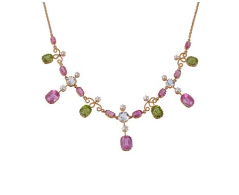 An Edwardian multi gem set necklace, circa 1910, set with step cut pink tourmalines and peridots, circular cut aquamarines an