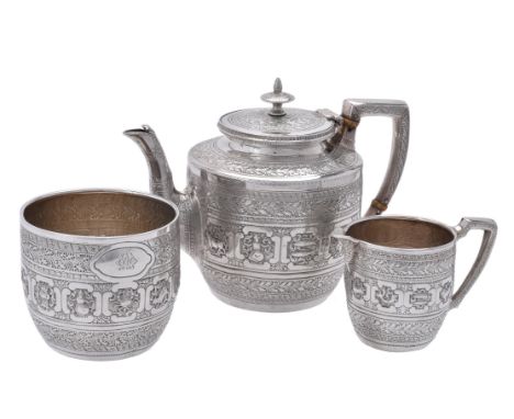 Y A Victorian Indian style three piece tea set by David Crichton Rait, Glasgow 1876, the tea pot with a cone finial to the sl