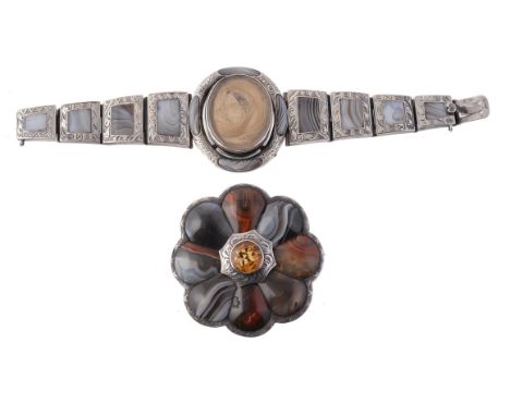 A late Victorian silver mounted Scottish agate brooch, circa 1880, centrally set with a circular cut citrine above a surround