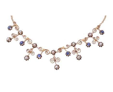 An Edwardian sapphire and half pearl fringe necklace, circa 1910, set with alternating mixed cut sapphire and half pearl drop