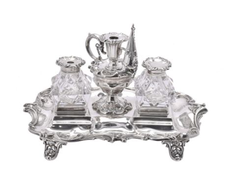 A Victorian silver shaped rectangular ink stand by Henry Wilkinson & Co., London 1858, with a chased foliate and C-scroll bor