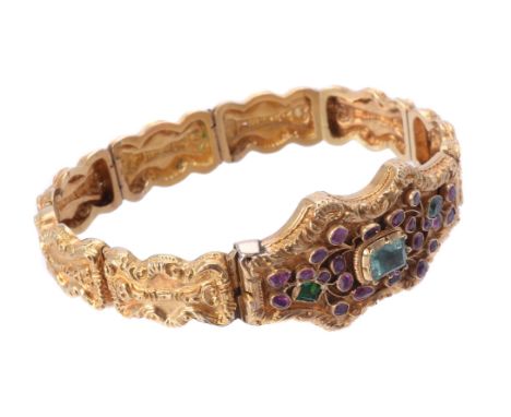 A Regency gold, ruby and emerald bracelet, circa 1830, the central clasp panel centrally set with a later step cut emerald, w