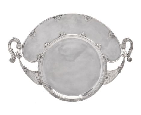 A Middle Eastern silver coloured twin handled tray, with twin scroll and reeded handles, a tongue and dart border and shells,