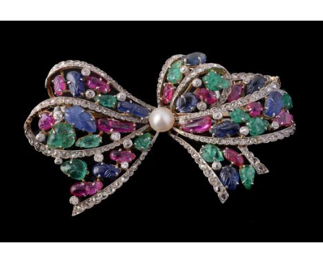 A multi gem set bow brooch, the looped style bow set with carved ruby, emerald and sapphire leaves and old cut diamonds, edge