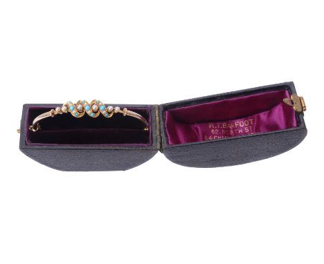A late Victorian turquoise and half pearl hinged bangle, circa 1900, the scrolled top set with half pearls and circular turqu