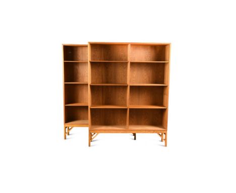 Børge Mogensen for FDB Møbelfabrik, a pair of Danish oak bookcases, with adjustable shelves raised on skeleton bracket feet (