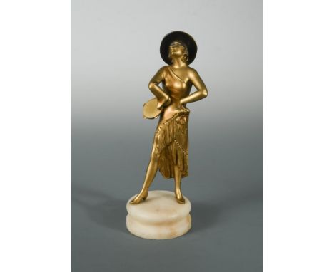An Art Deco gilt and patinated spelter model of a female tambourine player, raised on a circular onyx plinth base 27cm (11in)
