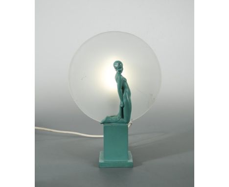 An Art Deco painted spelter figural table lamp, modelled as a kneeling female nude in front of a frosted glass roundel concea