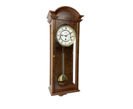 Comitti,  London - 20th century 8-day chiming wall clock in a walnut case, with a moulded break-arch top and full length glaz