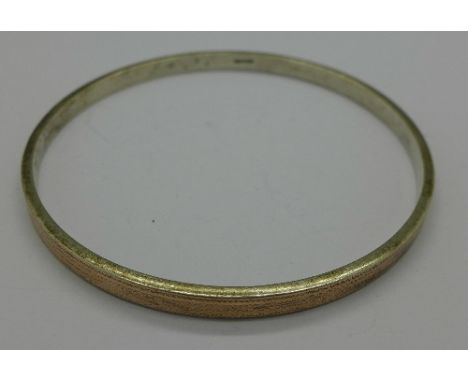 A 9ct gold and silver bangle, marked '9ct & sil'