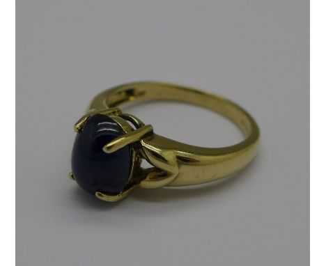 A 9ct gold ring set with a cabochon blue stone, 3.3g, N