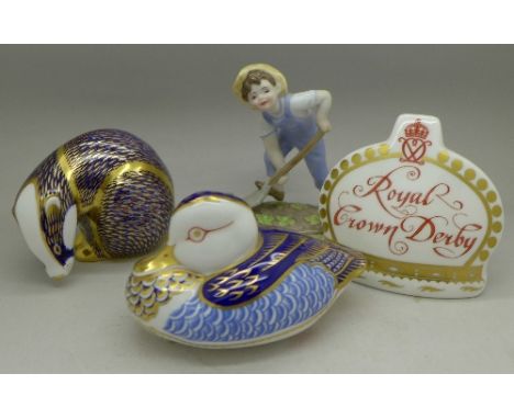 A Royal Worcester figure, two Royal Crown Derby paperweights, badger with gold stopper and duck with silver stopper and a Roy