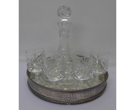 A silver plated stand with cut glass decanter and four glasses