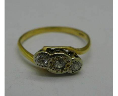 A yellow metal, three stone diamond crossover ring, 2.2g, Q