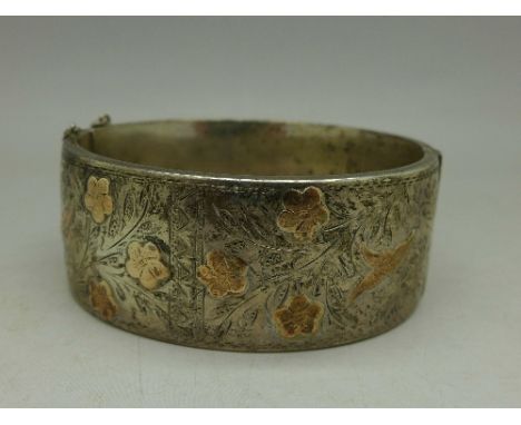 A silver and gold applied bangle