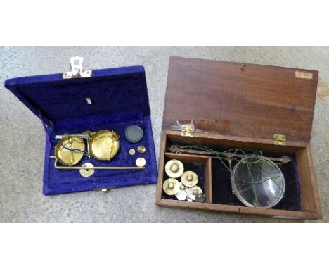 Two sets of balance scales, cased