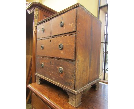 A small Georgian mahogany chest of two long and two short drawers, raised on short bracket supports, only 55cm wide