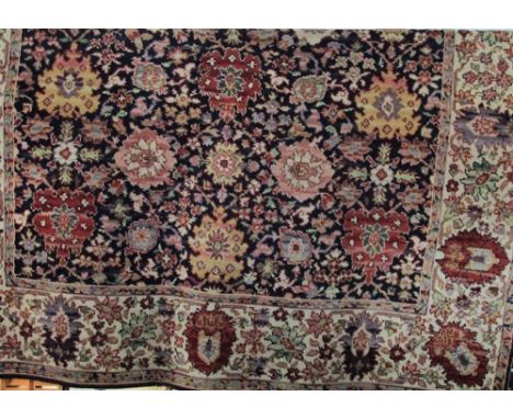 Large Axminster carpet decorated with thick floral sprays upon a navy blue ground, 360 x 275 cm 