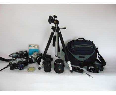 A collection of vintage photography including cameras, lenses, tripod stands, etc