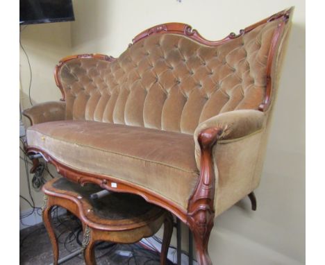 A Victorian mahogany drawing room sofa with carved and moulded show wood frame, buttoned back and raised on moulded cabriole 