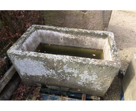 An excellent natural stone water trough of rectangular form with old lead rivet repair, still capable of holding water, 125cm