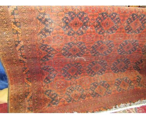 Persian carpet decorated with geometric Islamic panels upon a black and orange ground, 350 x 250 cm ; together with a further
