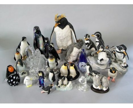 A collection of ceramic and glass models of penguins including a Royal Dux example, 15 cm tall, a Country Artists natural wor