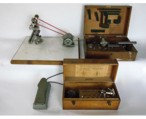 A watchmakers lathe with two wooden boxes containing a collection of lathe tools