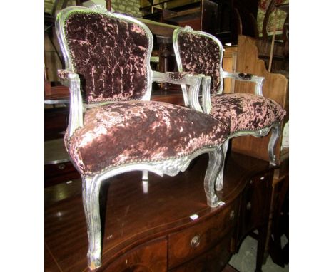 A pair of open armchairs, with overstuffed serpentine sprung seats and button backs within shaped moulded and carved frames w