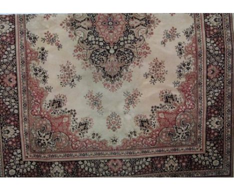 Kashmir carpet decorated with dark panels upon a beige ground, 340 x 250 cm