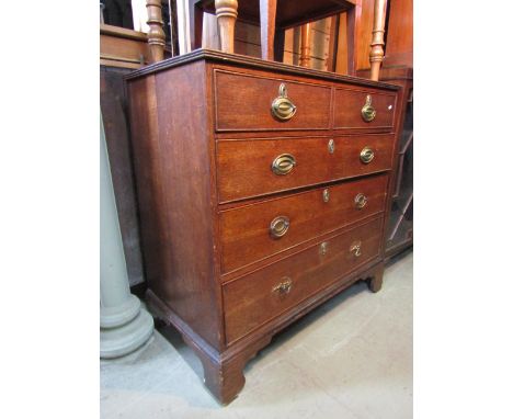 A Georgian oak bedroom chest of three long and two short graduated drawers, raised on bracket supports, 102cm wide approx