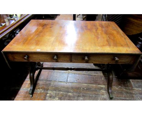 A Georgian mahogany sofa table of usual form fitted with two real and two dummy drawers, raised on a stretcher framework with